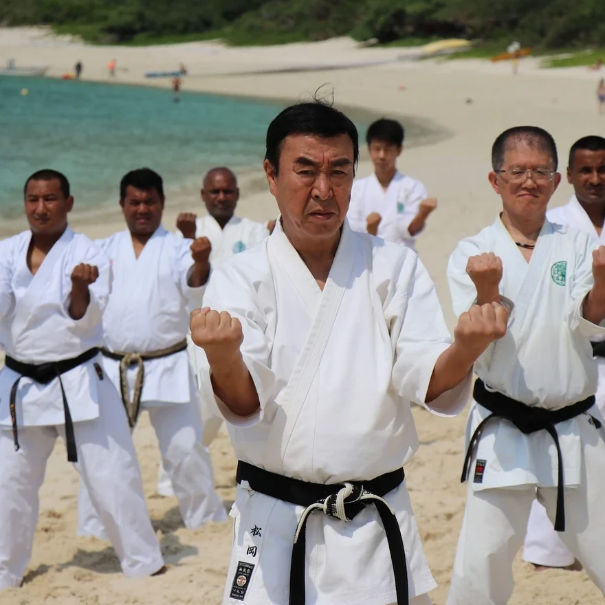 Group of karateka training on a beach
