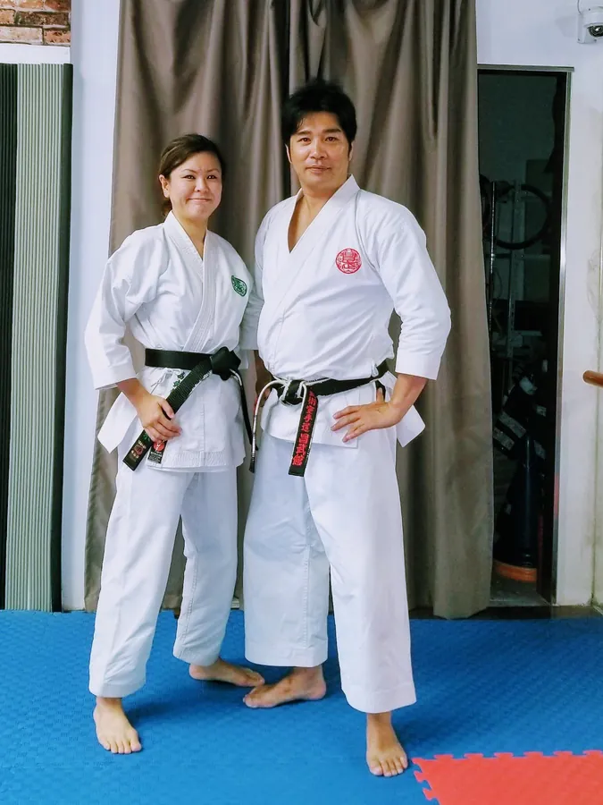 Two Ageshio Japan karate instructors in gi standing for a studio portrait