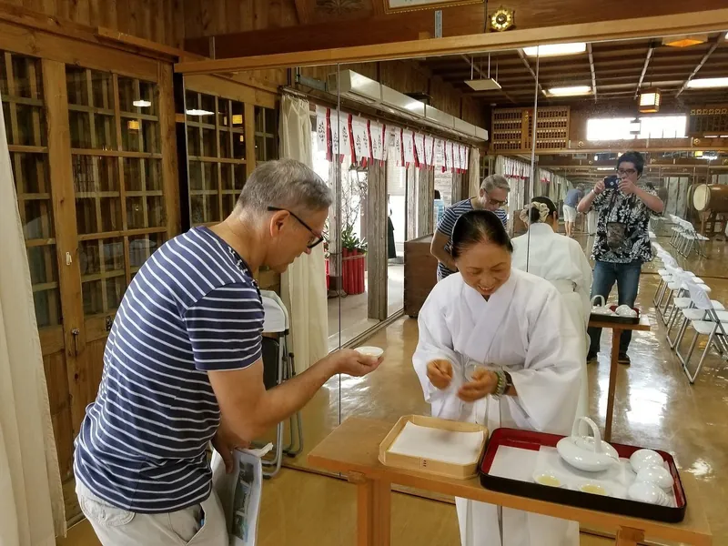 Visitor taking part in a traditional Okinawan tea ceremony